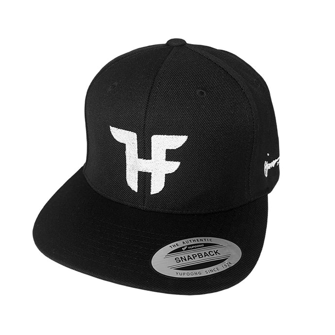 Black hat with white with Tjing Ambassador Hjalmar Fredriksson's personal logo embroidery on the front panel and signature on the side rim. Snapback enclosure at the back – one size fits most.