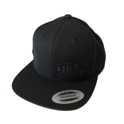 Black hat with black Tjing logo embroidery on the side front panel, snapback enclosure in the back – one size fits most.
